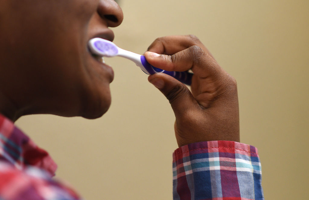 The oldest Coyote Hill resident brushes her teeth